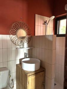 a bathroom with a sink and a mirror at Quiet Villa Near Sea, Cotonou in Sèmè-Podji