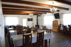 a dining room with tables and chairs and chandeliers at Casa Eby in Vidolm