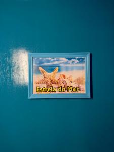 a picture of a starfish on a blue wall at Guest House Rosa do Mar in Olinda