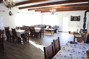a dining room with tables and chairs and a couch at Casa Eby in Vidolm