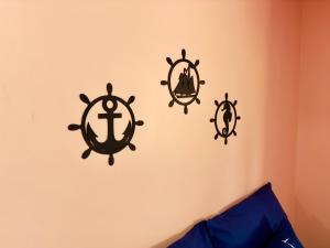 three black anchors on a wall in a bedroom at Guest House Rosa do Mar in Olinda