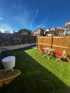 a backyard with a table and chairs and a fence at Cosy Studio Fréjus Centre Historique in Fréjus