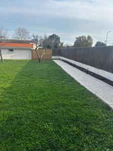 a backyard with a fence and a grass yard at Cosy Studio Fréjus Centre Historique in Fréjus