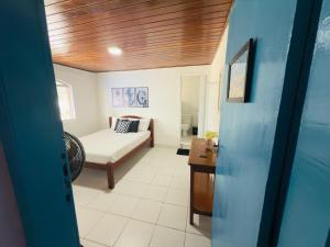 a living room with a couch and a table at Guest House Rosa do Mar in Olinda
