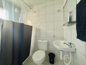 a small bathroom with a toilet and a sink at Guest House Rosa do Mar in Olinda +37 photos