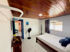 a bedroom with a bed and a wooden ceiling at Guest House Rosa do Mar in Olinda