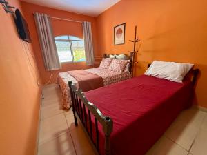 a small bedroom with two beds and a window at Guest House Rosa do Mar in Olinda