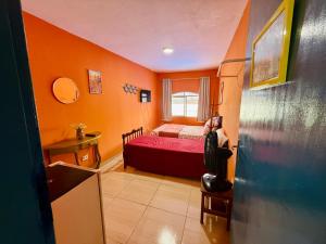 a small bedroom with a bed in a room at Guest House Rosa do Mar in Olinda