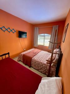 a bedroom with two beds and a window at Guest House Rosa do Mar in Olinda