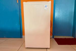 a white refrigerator in the corner of a room at Guest House Rosa do Mar in Olinda