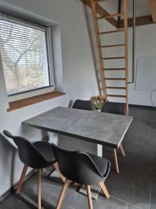 a dining room with a table and chairs at Haus Evelynchen Apartment 2 Deutschhof in Deutschhof