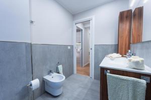 a bathroom with a white toilet and a sink at BG Apartments - Central and quiet one-bedroom flat in Sestri Levante