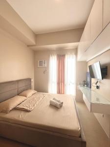 Ένα ή περισσότερα κρεβάτια σε δωμάτιο στο Casa Kristine Suite Avida Atria Tower 3