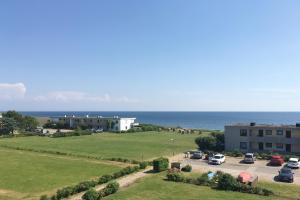 a view of a parking lot and the ocean at FEWO Ferienresidenz Staberdorf Haus 76 Wohnung Nr 26 in Staberdorf