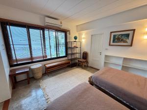 a bedroom with a bed and a desk and a window at Rare, Special Beach Pool Villa in Hua Hin +52 photos