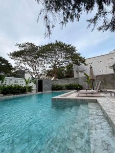 a swimming pool with blue water in front of a building at Rare, Special Beach Pool Villa in Hua Hin