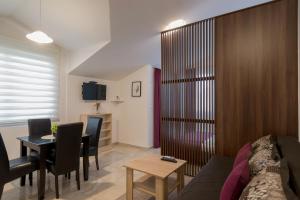a living room with a couch and a table at Apartments Sunrise in Herceg-Novi