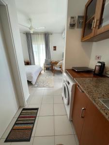 a small kitchen with a bed in a room at Fumba Town Tausi Apartments in Zanzibar City +30 photos