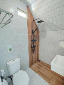a bathroom with a toilet and a sink at Tria Maria Cottage in Ngurblut