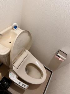 a bathroom with a toilet with a remote control at ZYZSumiyoshichō 2K SJ0254 in Tokyo