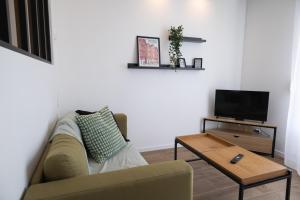 a living room with a couch and a coffee table at Troyes - Aux pieds du cube in Troyes +15 photos