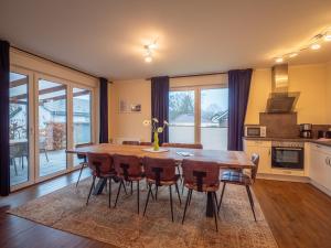 a dining room with a wooden table and chairs at Terra am Plauer See m Garten in Malchow