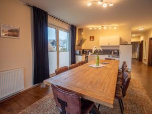 a kitchen and dining room with a wooden table and chairs at Terra am Plauer See m Garten in Malchow