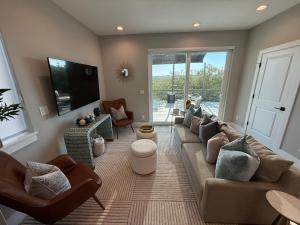 a living room with a couch and a tv at Modern Sanctuary in Saint Augustine in St. Augustine