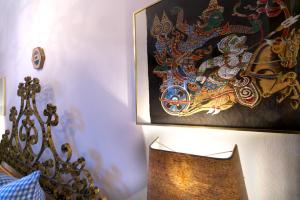 a painting on the wall next to a bed at Manuel -560- in Mittenwald