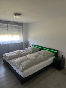 a bedroom with two beds with green lights on them at Ferienwohnung Dadaa in Albstadt