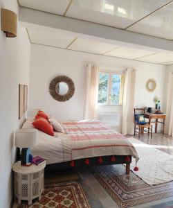 a bedroom with a large bed with red pillows at Casa Louisa in Serralongue