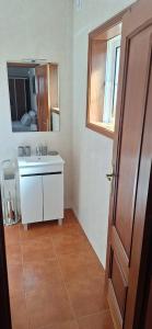 ein Badezimmer mit Waschbecken und Spiegel in der Unterkunft Martins House Quartos in Arouca