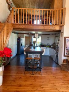 a kitchen with a wooden floor and a staircase at maison en bois en bord d'Herault in Saint-Bauzille-de-Putois