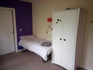 a bedroom with a bed and a white cabinet at Burntisland Near Edinburgh with Hot Tub in Burntisland