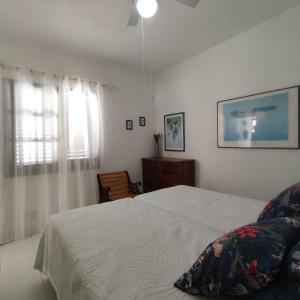 a bedroom with a white bed and a window at Vista Mar Sardina in Gáldar +18 photos