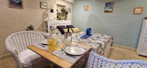 a dining room with a table and a bed at Lou pichoun studio au coeur d'un village provençal in Gargas +37 photos