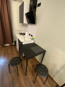 Un escritorio y dos sillas en una habitación. en EksPorta Apartments 2, en Riga 3 fotos más