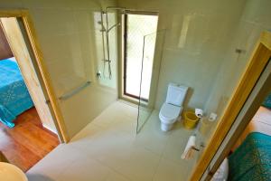 a bathroom with a shower and a toilet at Paradise Holiday Homes Rarotonga in Rarotonga +14 photos