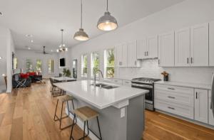 a kitchen with white cabinets and a large kitchen island at Muncie U Too at Trinity Grove in Dallas