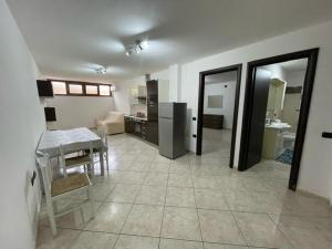 a room with a kitchen and a dining room at Comfort Apartment in Assemini