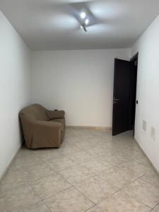 a living room with a couch and a ceiling fan at Comfort Apartment in Assemini +1 photo