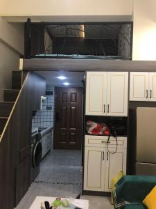 a small kitchen with a bunk bed in it at Smart Ruoqi B&B in Kunming