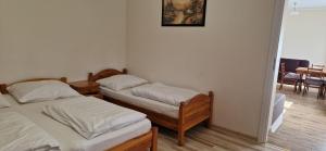 two twin beds in a room with a mirror at Domek Salent in Mrągowo