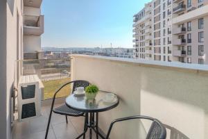 a small table and chairs on a balcony with a view at Cream Divine in Oradea