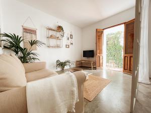 a living room with a couch and a tv at Portal Vell Altea in Altea