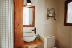 a bathroom with a bowl sink and a toilet at Portal Vell Altea in Altea +14 photos