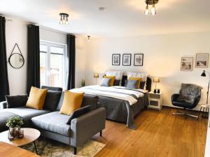 a bedroom with a bed and a couch at Ferienwohnung Stamer in Eckernförde +9 photos