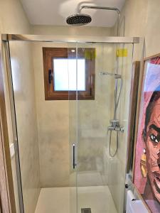 a bathroom with a shower with a glass shower stall at ElsPeixets Home Mallorca - ArtHouse in Colonia Sant Jordi