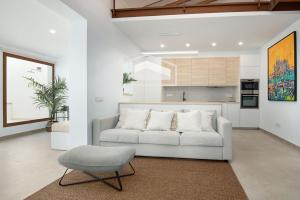 a living room with a couch and a chair at ElsPeixets Home Mallorca - ArtHouse in Colonia Sant Jordi