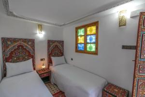 Postel nebo postele na pokoji v ubytování Dar Amazigh